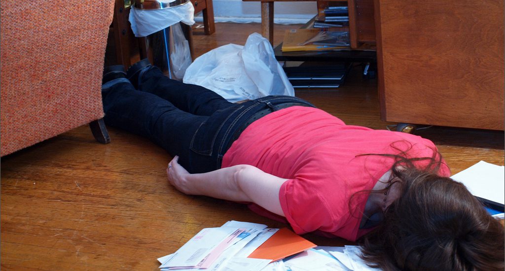 A woman lying face down on a pile of mail. It's nearly impossible to motivate others, and that shouldn't be our goal as leaders.