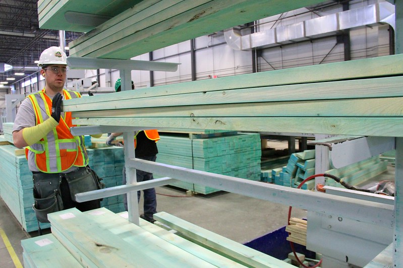 Photo of a green manufacturing worker in the Landmark Homes manufacturing plant in Edmonton Alberta.
